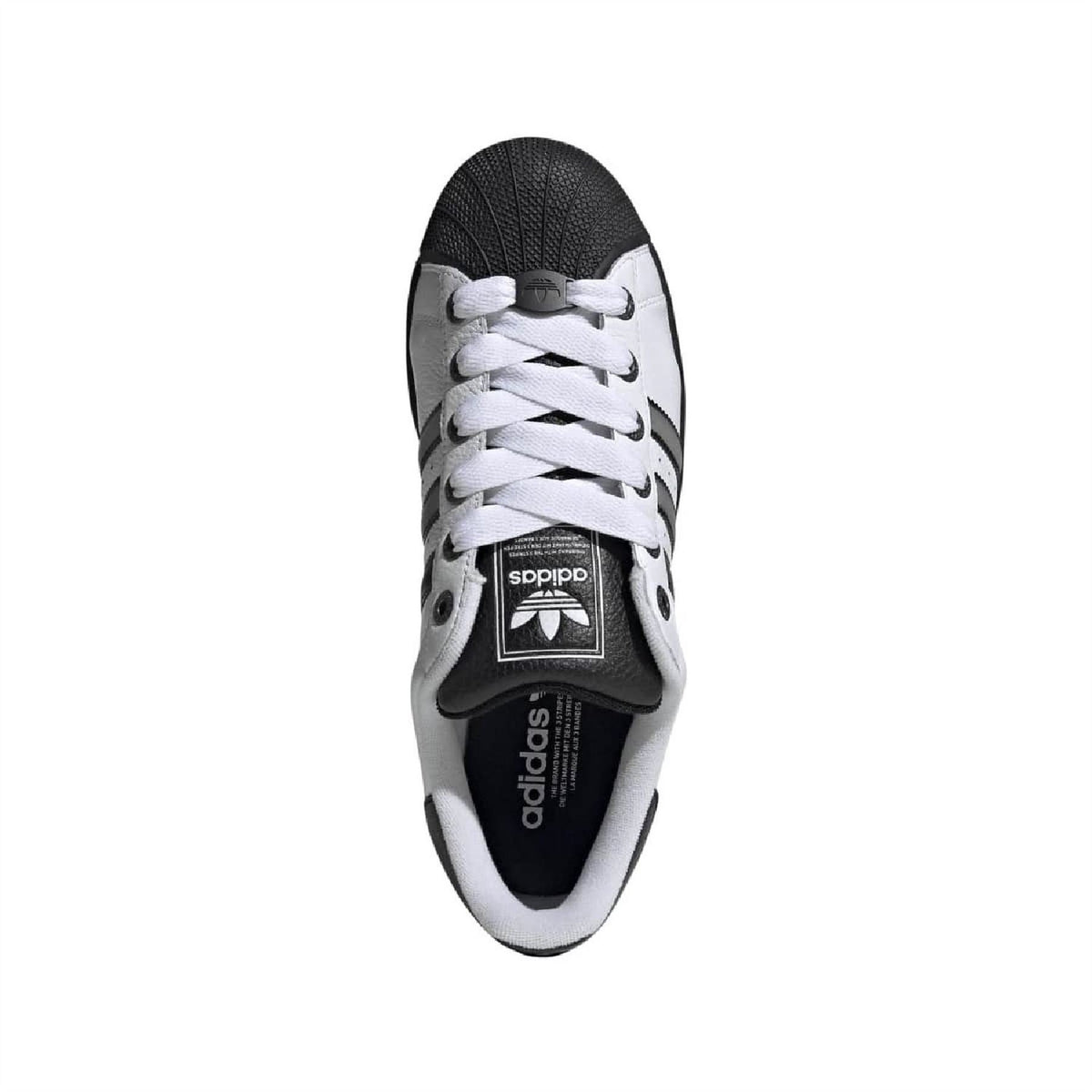 White leather lace-up sneakers with black tongue label and textured toe cap