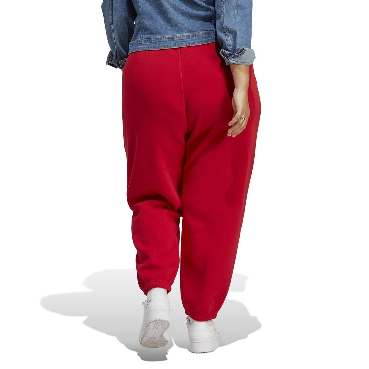 Red tapered joggers on model with cuffed ankle and elastic waistband