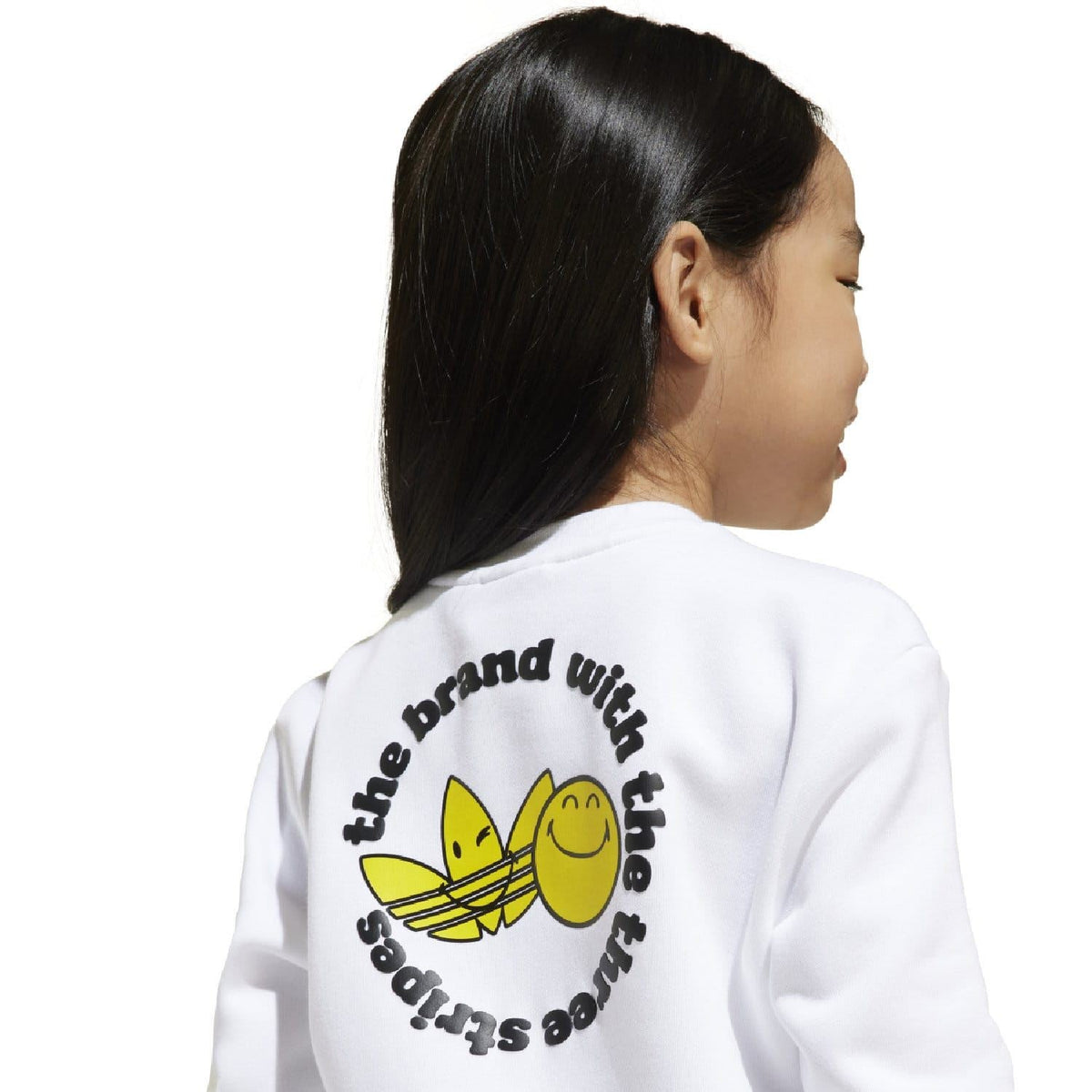 Kids white crew sweatshirt with back print: yellow Smiley face with curved text graphic.