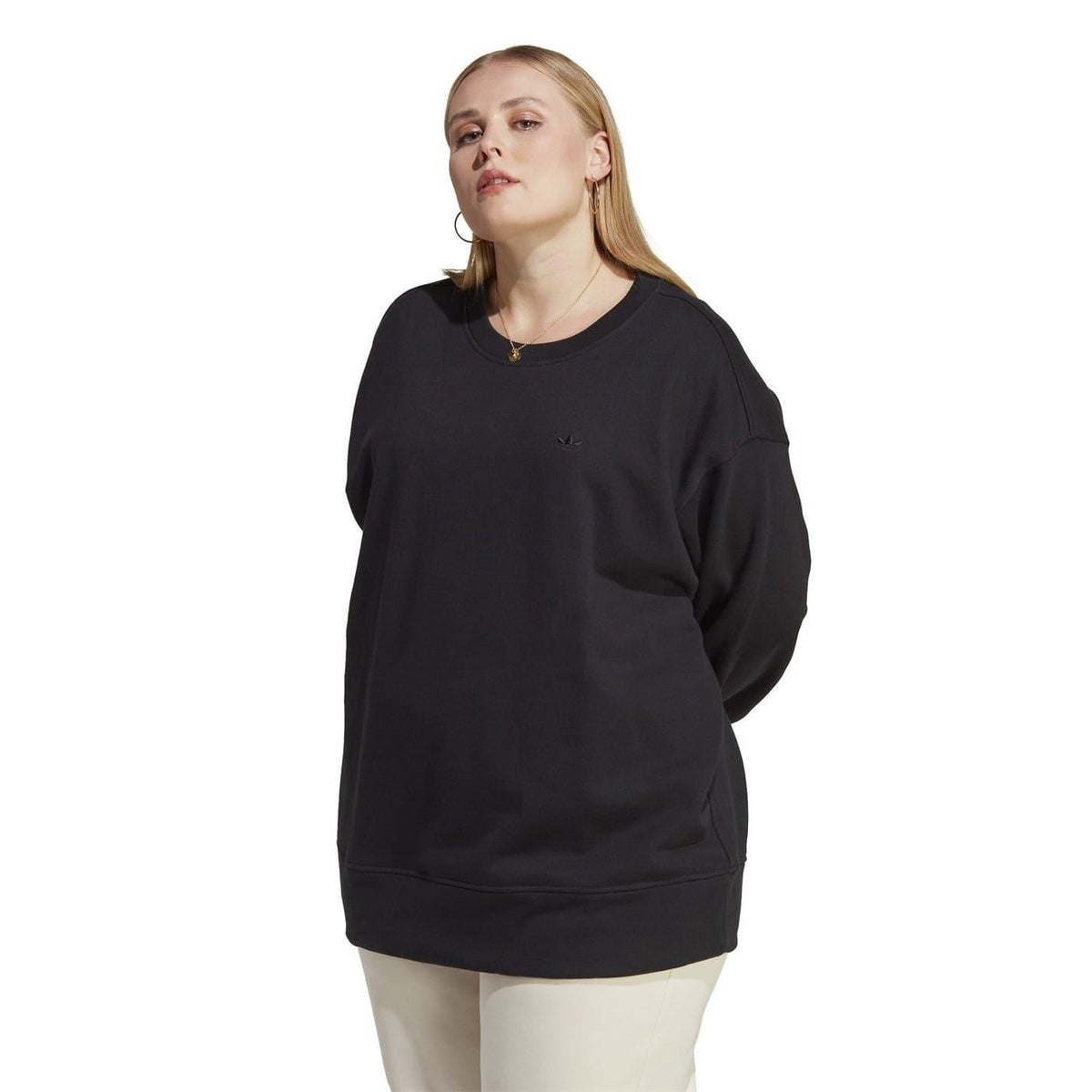 Black cropped sweatshirt on model with dropped shoulders and ribbed hem