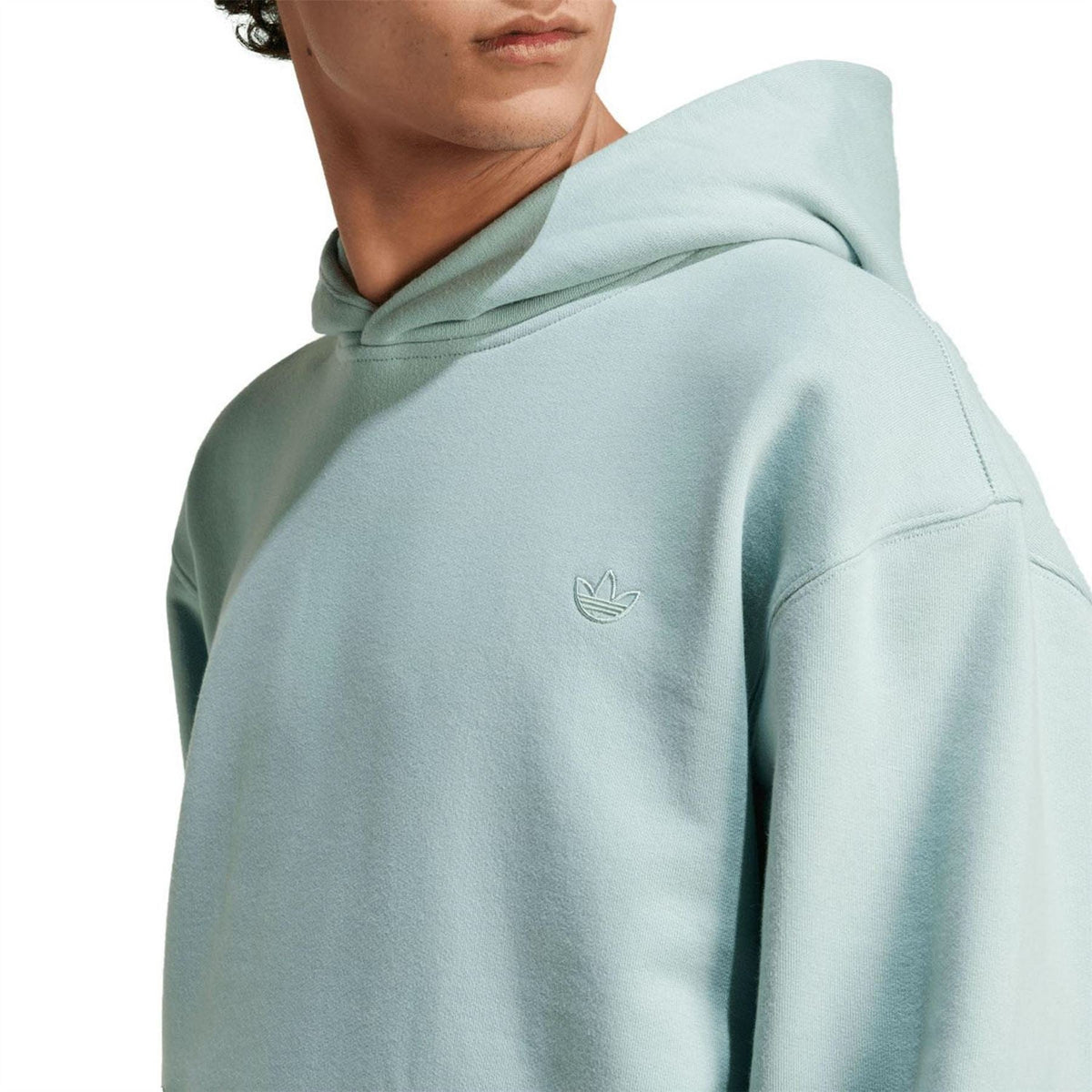 Light green hoodie with small adidas trefoil logo on chest