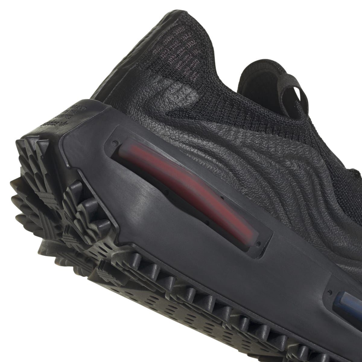 Black adidas Originals NMD S1 trainer midsole detail with red window panel