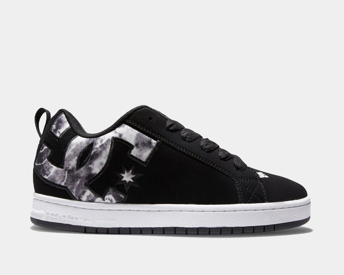 Black low-top sneakers with lace-up front, star graphic, and white midsole