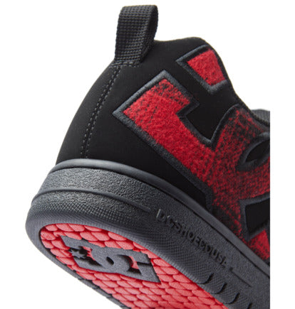 Heel close-up of black sneaker with red graphic panels and textured outsole