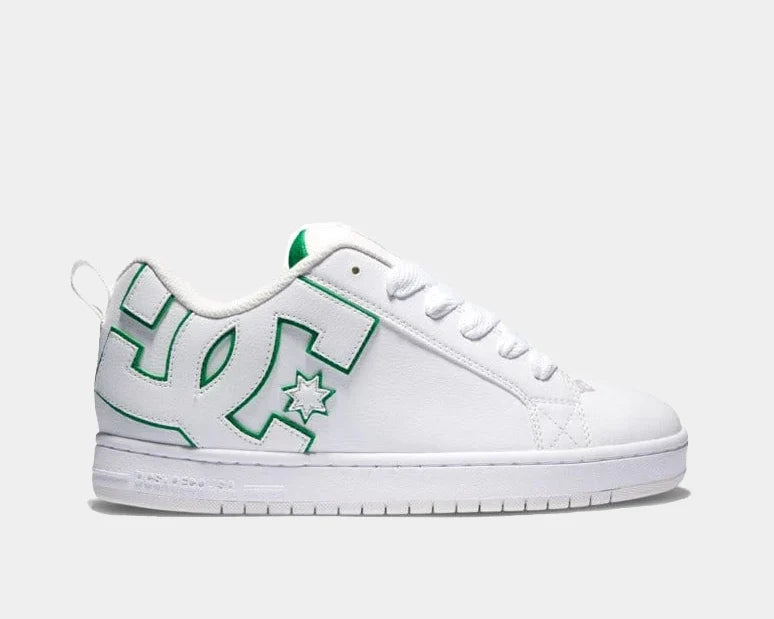 White low-top sneakers with green logo patches and star graphic