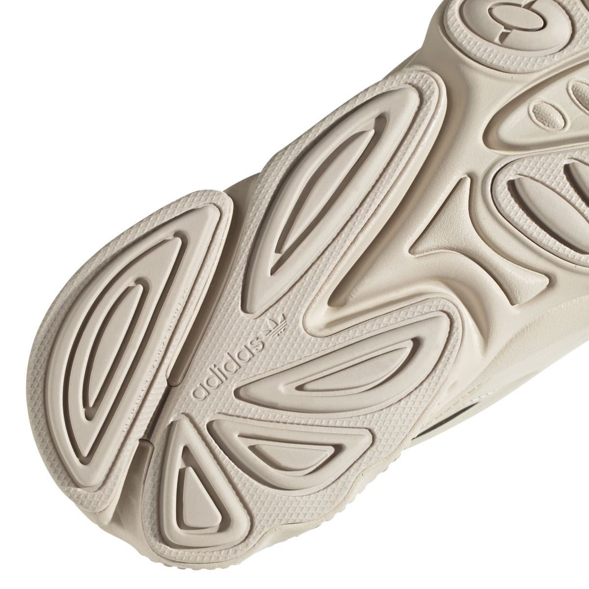 adidas Ozweego trainers outsole close-up in light cream with deep tread grooves