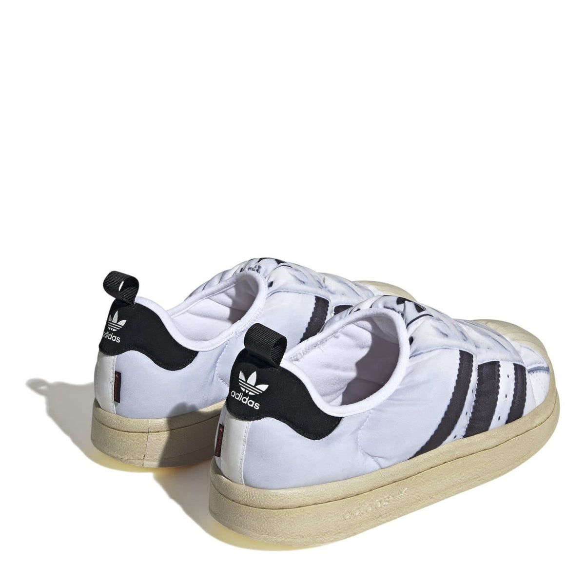adidas Originals Puffy Spr trainers with three white stripes, showcasing the stylish footwear design and textured puffy exterior.