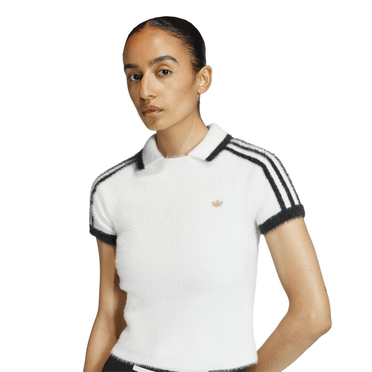 adidas Originals womens white polo shirt close-up with black shoulder stripes and gold logo
