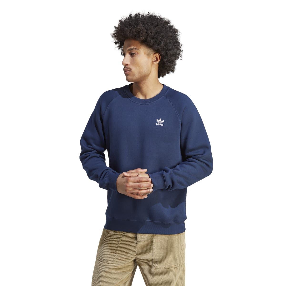 Navy crewneck sweatshirt with adidas trefoil logo, worn with tan pants