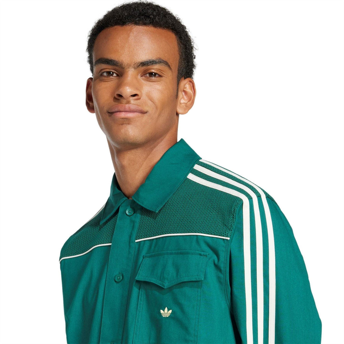 Green button-up jacket close-up with stand collar, chest pocket, trefoil, white sleeve stripes