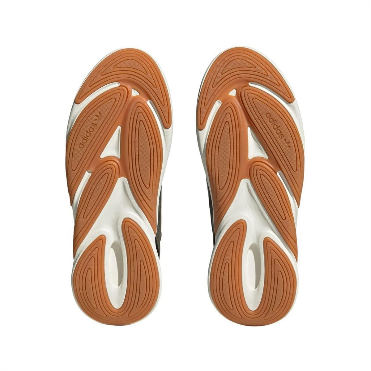 Outsole view of trainers with orange traction tread and adidas logo