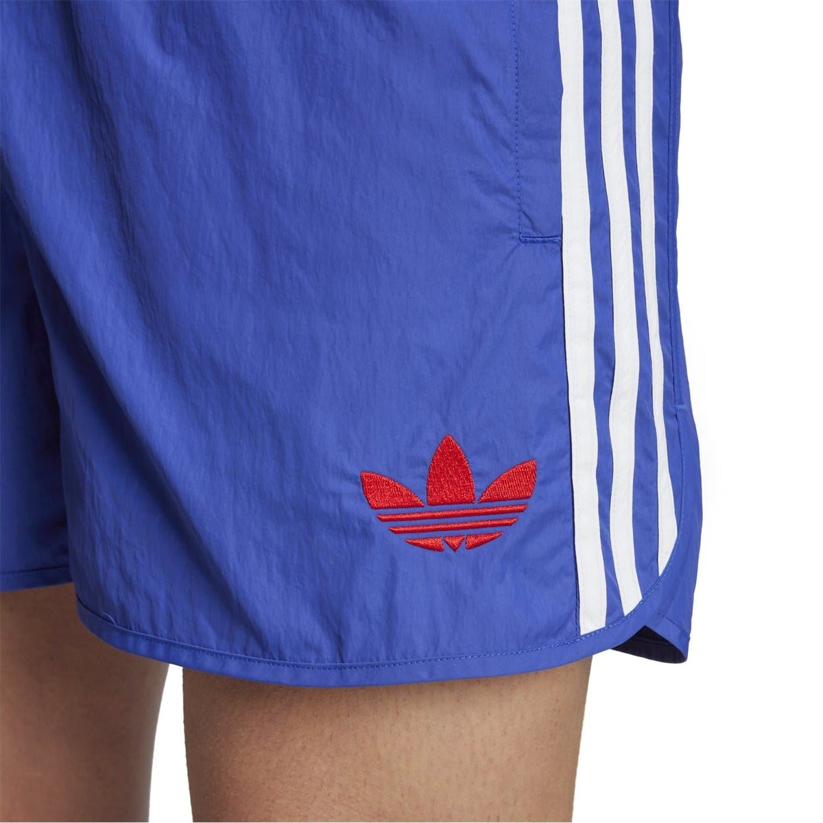 Blue shorts detail with red trefoil logo and white side stripe taping
