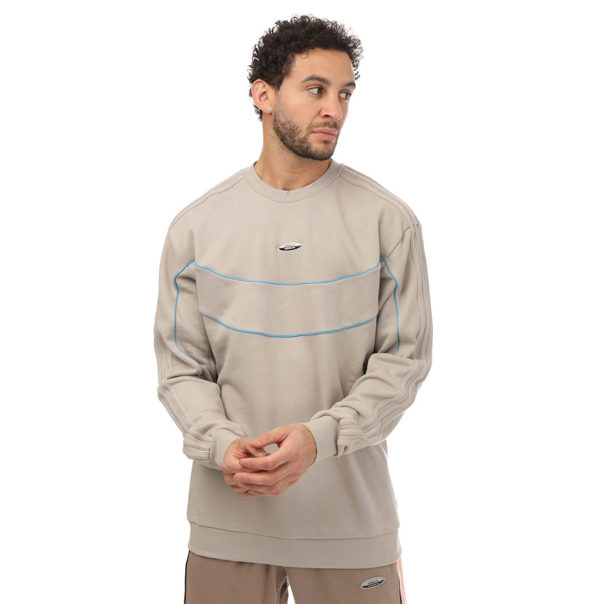 Light beige crewneck sweatshirt with blue contrast stripes and adidas logo patch