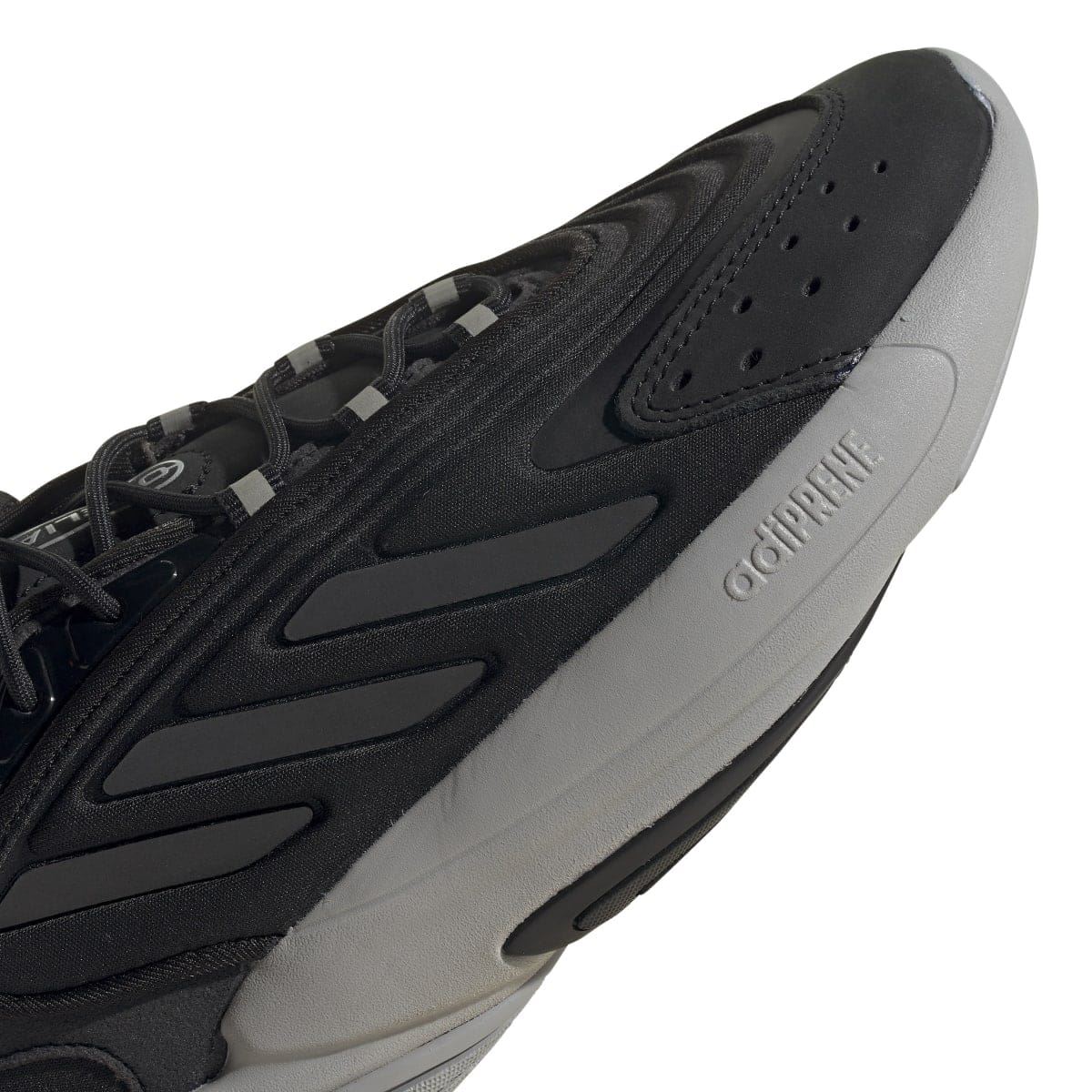 Close-up of black perforated toe and side panel with gray heel branding