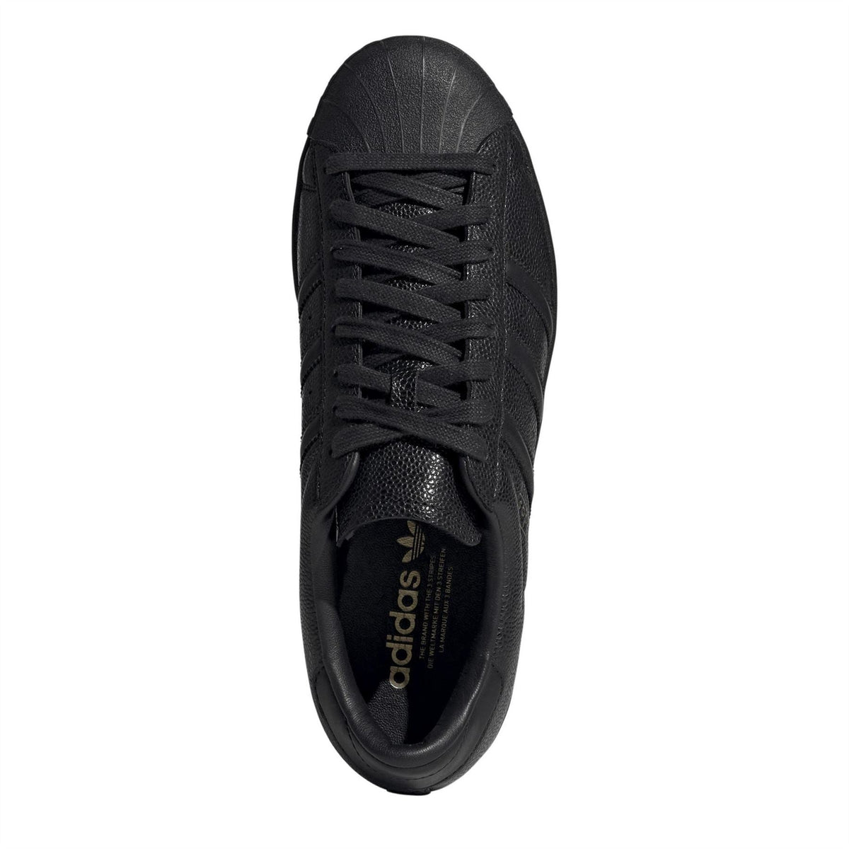 Black lace-up sneakers with adidas label inside the tongue