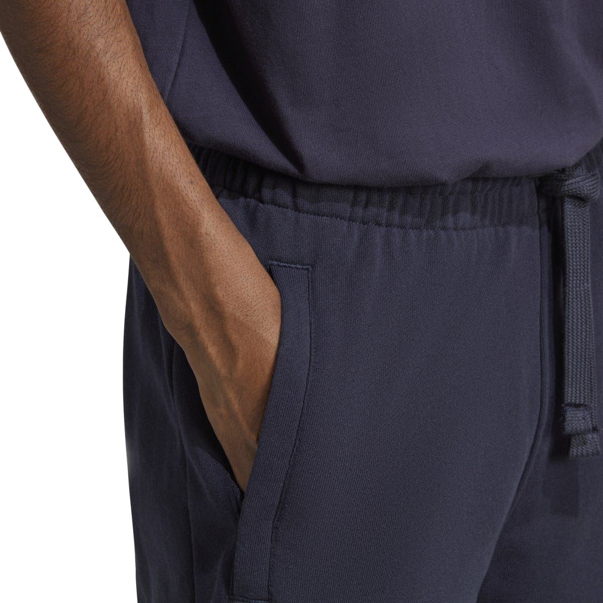 Navy joggers close-up: side seam pocket and elastic waist detail