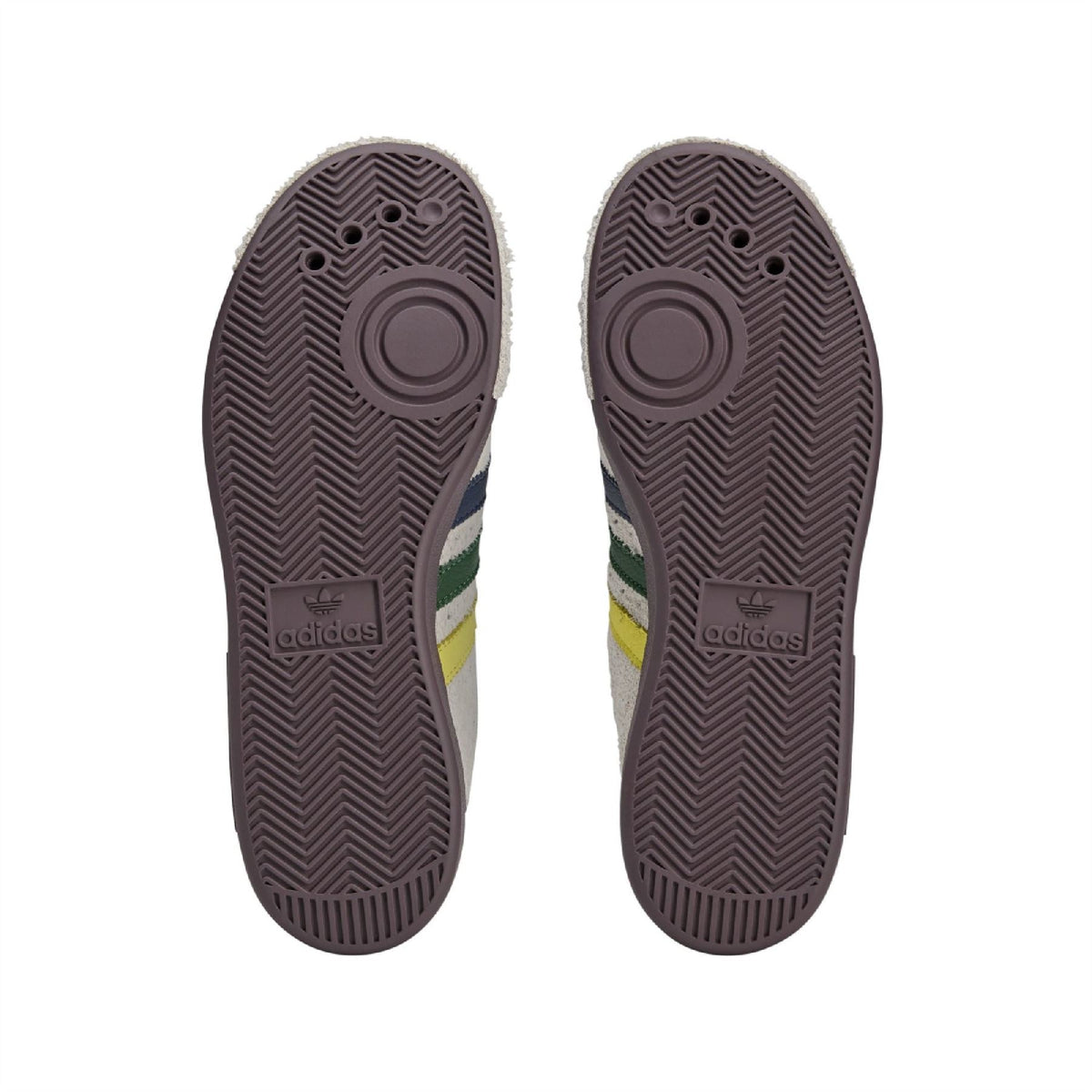 Brown rubber sneaker outsoles with adidas logo and textured tread pattern