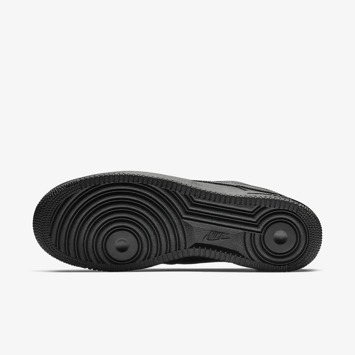 Black rubber outsole of low-top sneakers with textured traction pattern