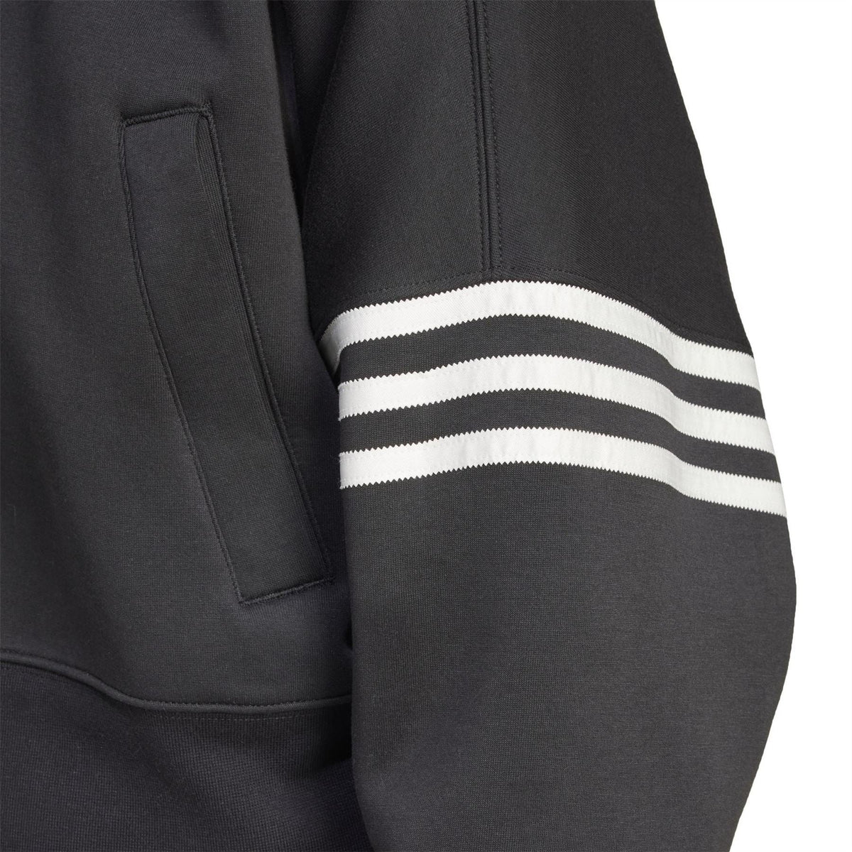 Black track top sleeve with contrast white striped band and flap pocket