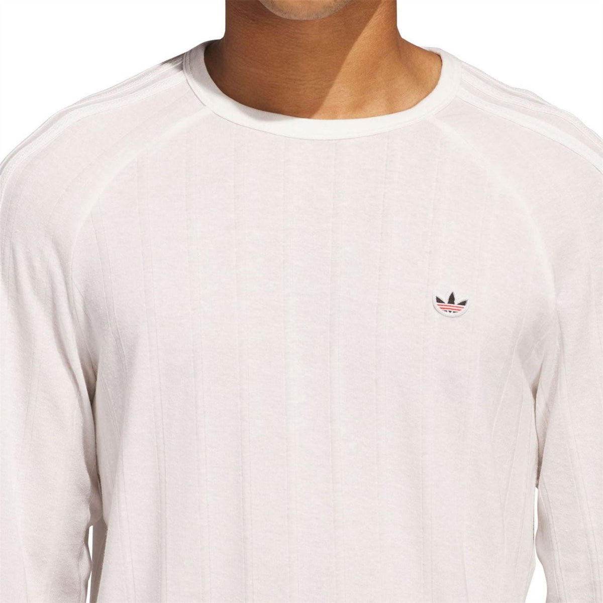 White long sleeve t-shirt chest logo detail; crew neck and ribbed cuffs
