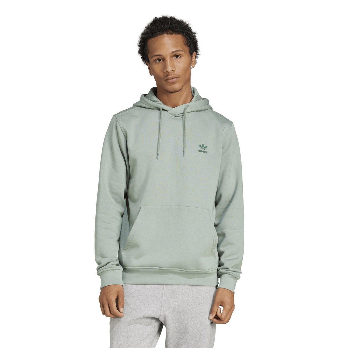 Light sage green adidas Originals Ess hooded sweatshirt on model, front view with drawstring