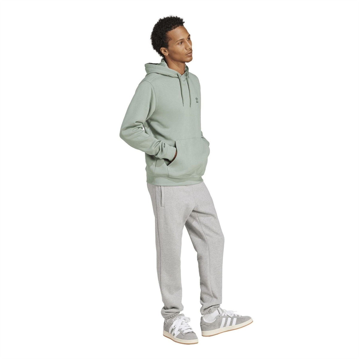 Light sage green adidas Originals Ess hooded sweatshirt on model, side view