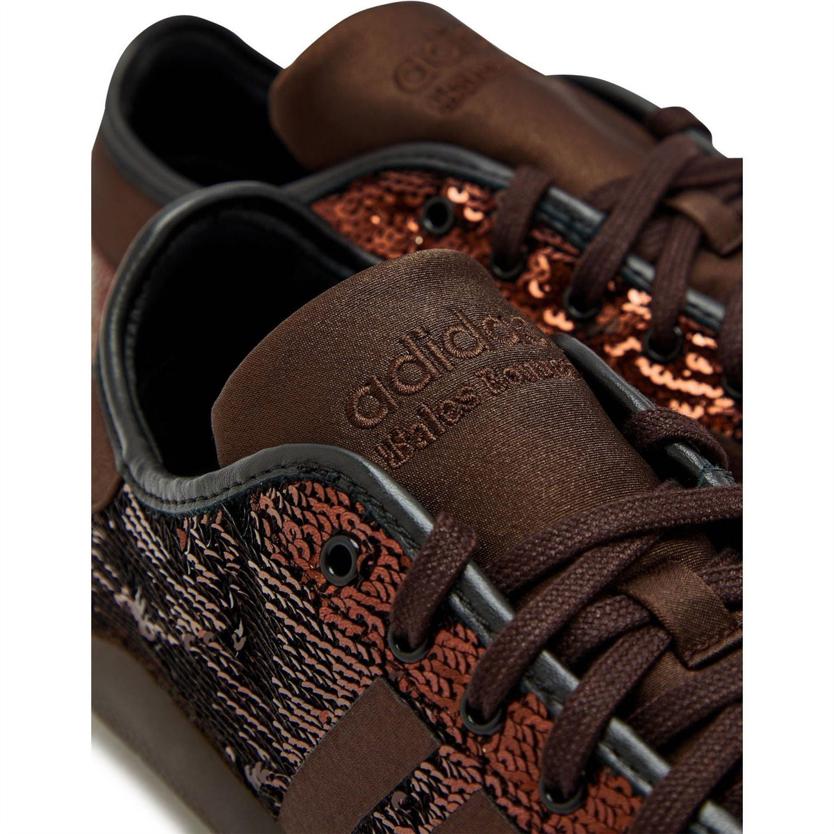 Close-up of brown adidas Originals sequin sneaker tongue and laces