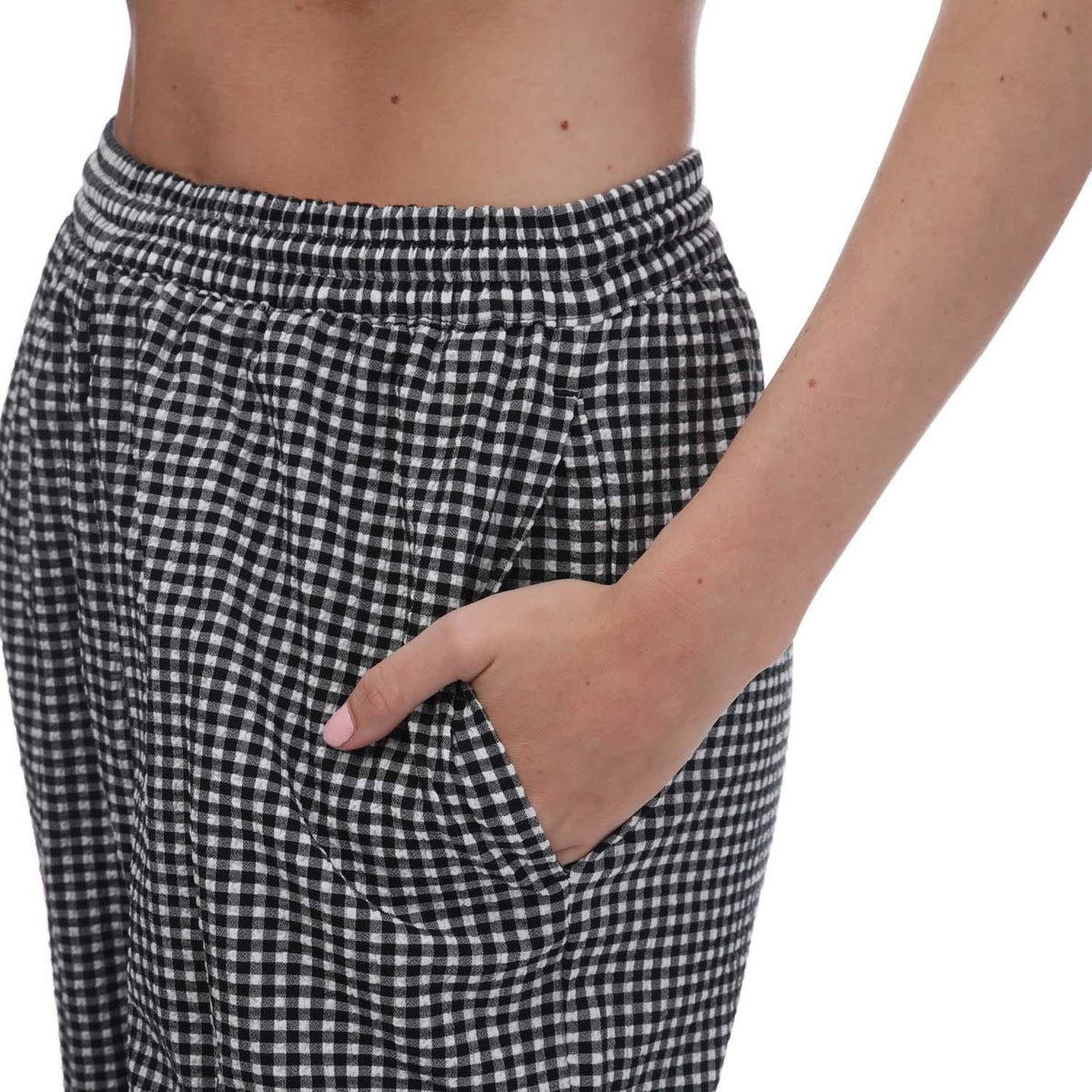 adidas Originals Gingham track pants showing a relaxed fit with black and white checkered pattern, made for casual comfort and style