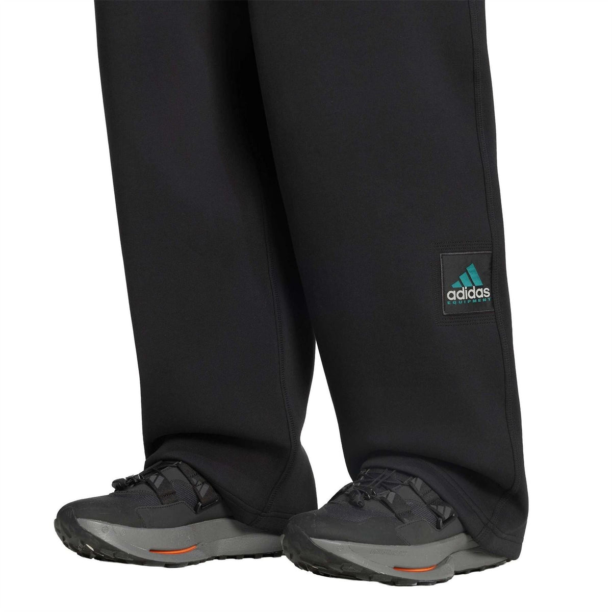 Black adidas EQT pants with ankle cuff and adidas label patch on thigh