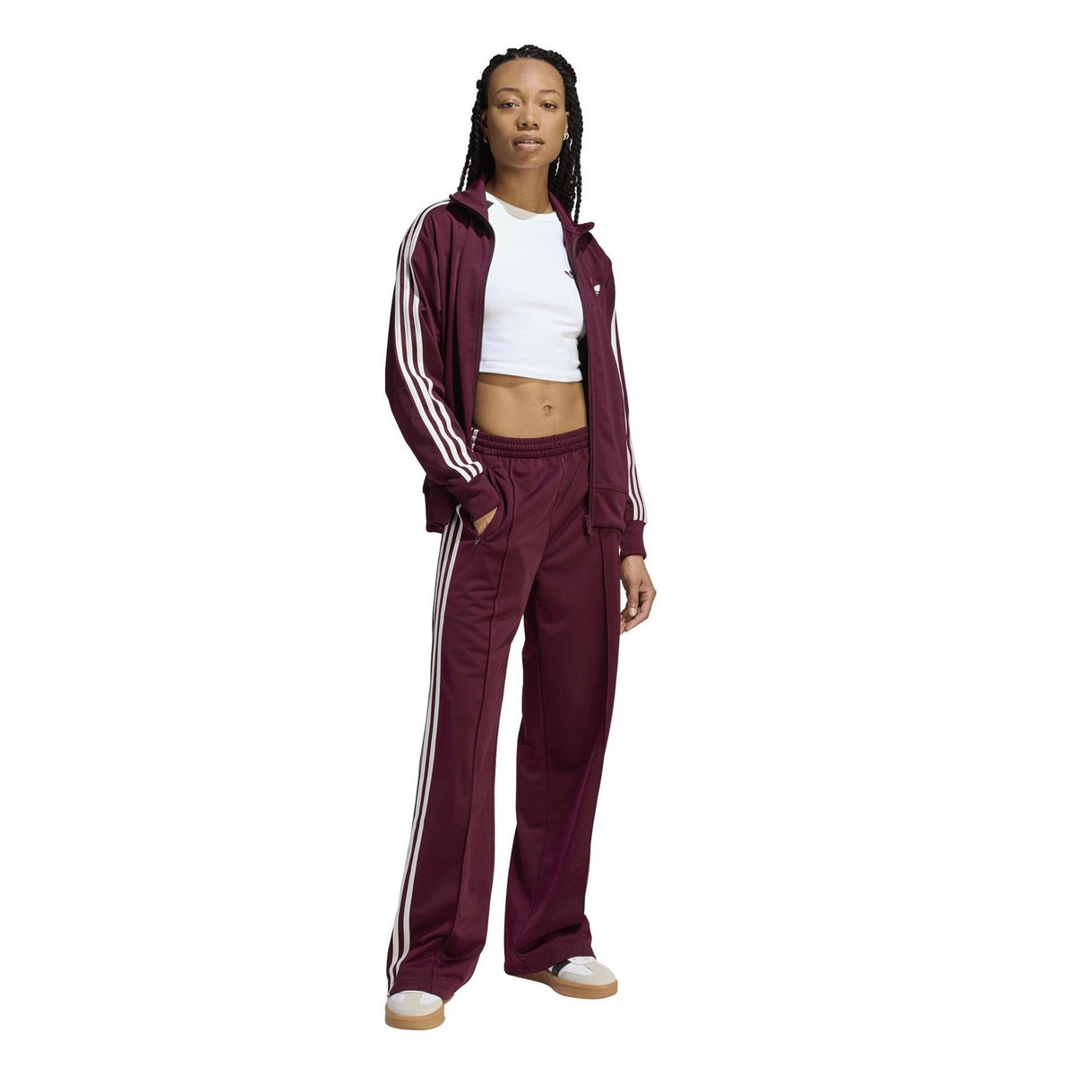 Maroon track pants with white triple side stripes and relaxed wide-leg fit