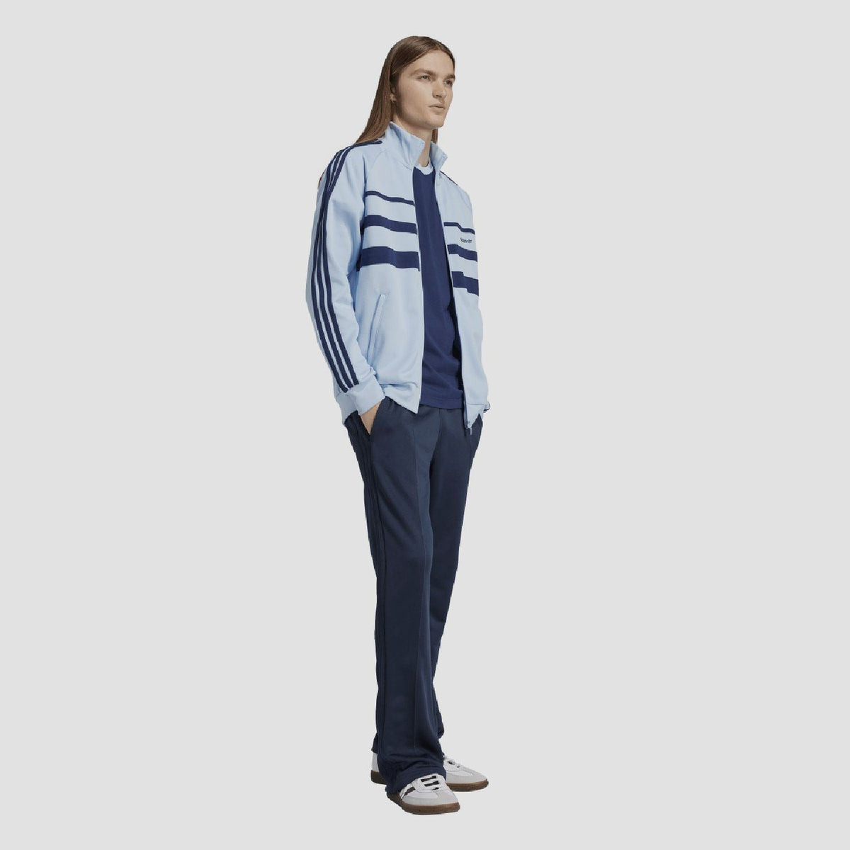 Indigo T-shirt neckline visible under adidas track jacket