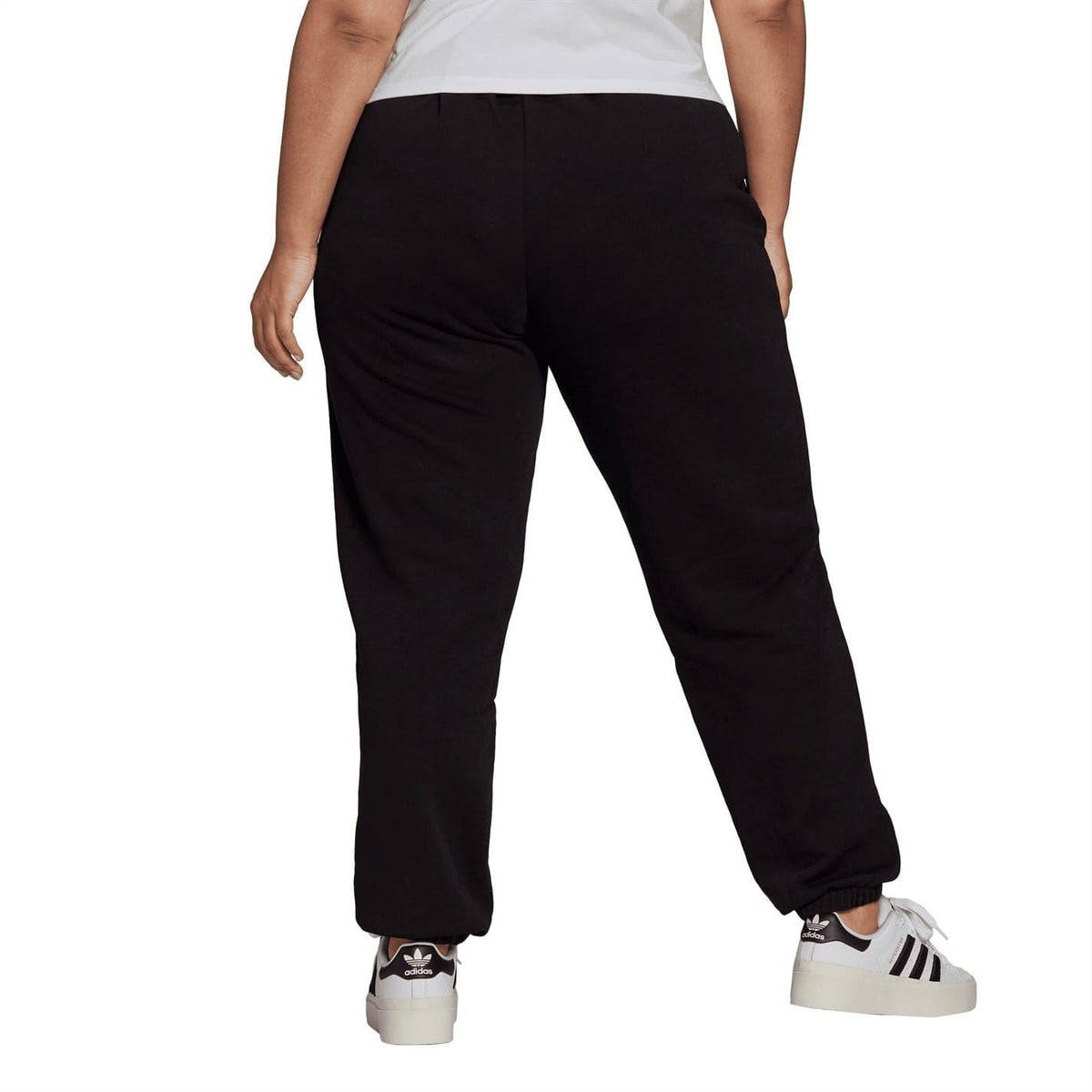 Black tapered track sweatpants with drawstring waist and adidas branding