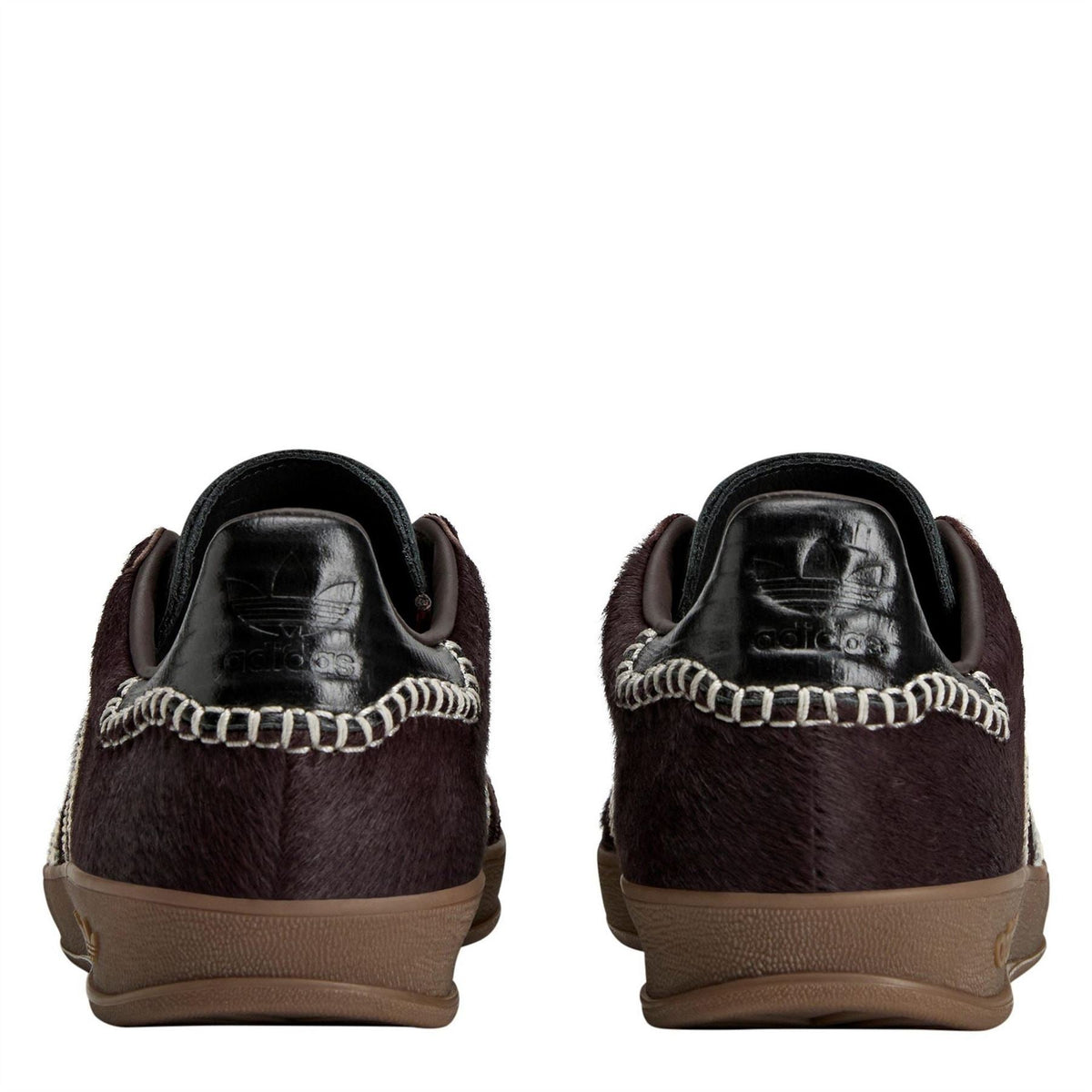 Back view of dark pony Gazelle shoes with chain-trim heel and brown gum soles.