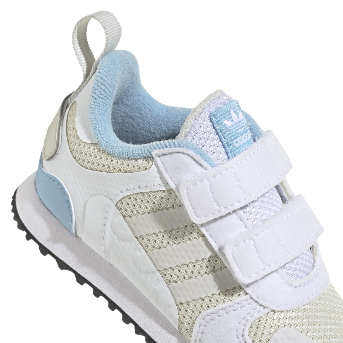 Infant white and light-blue trainers with hook-and-loop strap, mesh side panel, and rubber sole
