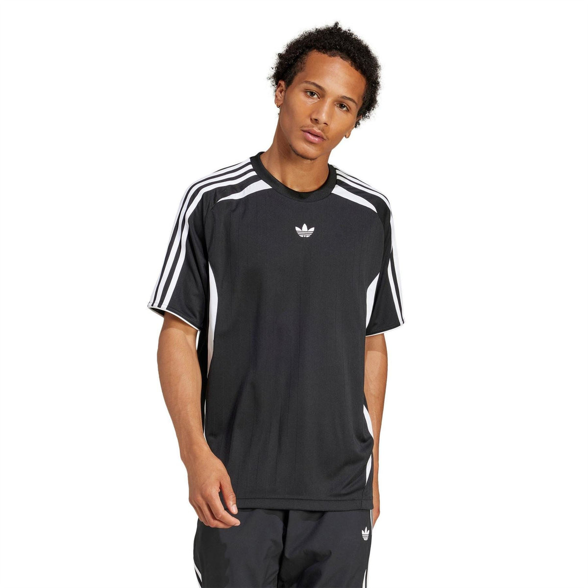 Black adidas Originals Teamgeist tee on model, with white shoulder stripes and trefoil logo