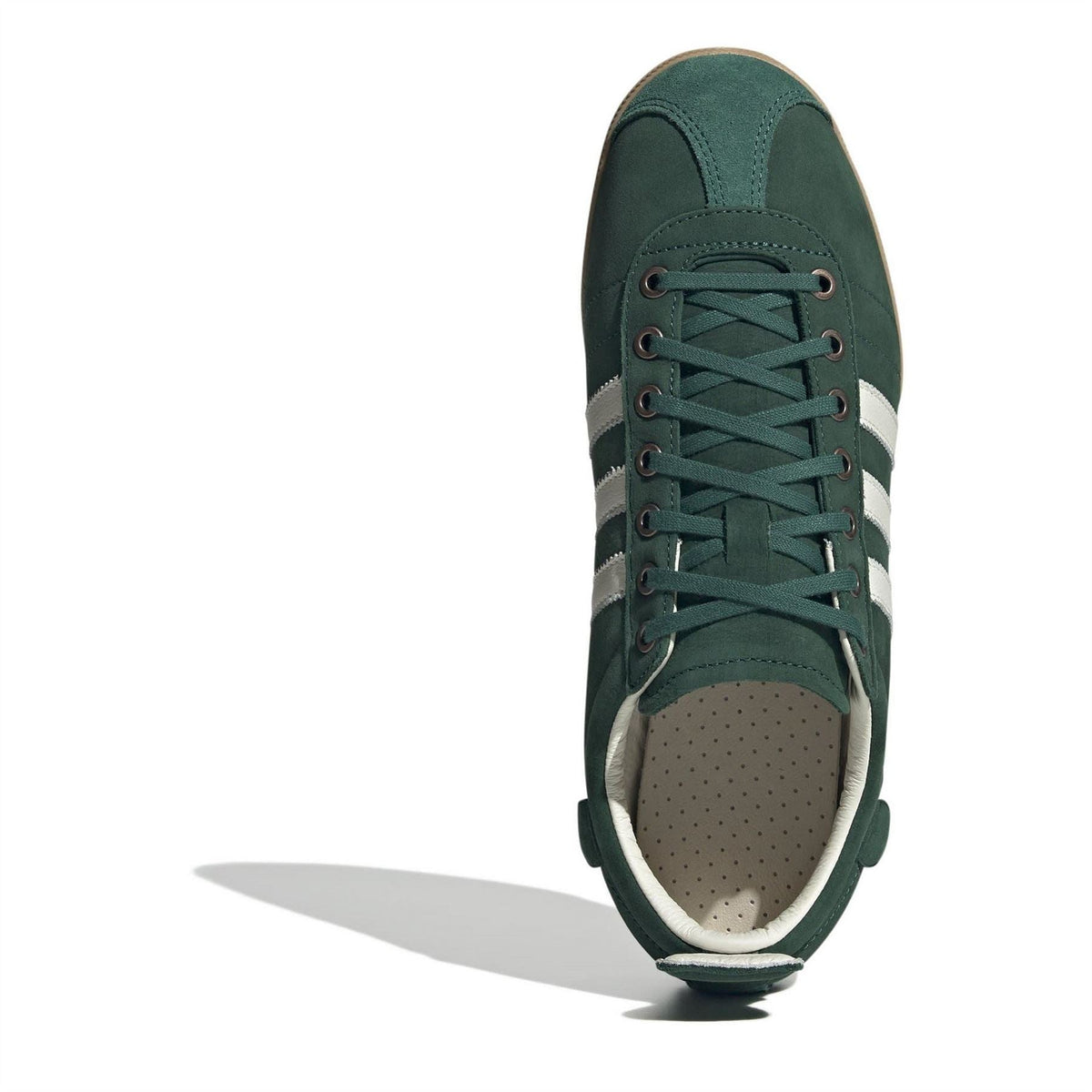 Green suede low-top sneakers with lace-up front and perforated toe lining