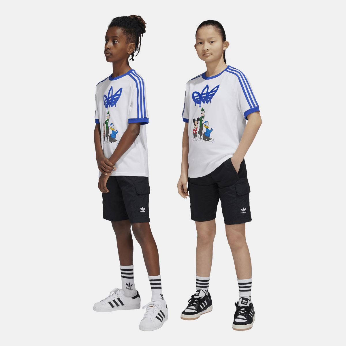 Blue adidas Originals juniors cargo shorts for kids aged 8-16, featuring multiple pockets and adjustable waistband.
