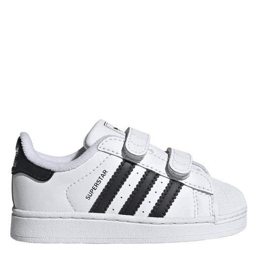 White leather low-top sneakers with black three stripes and hook-and-loop straps