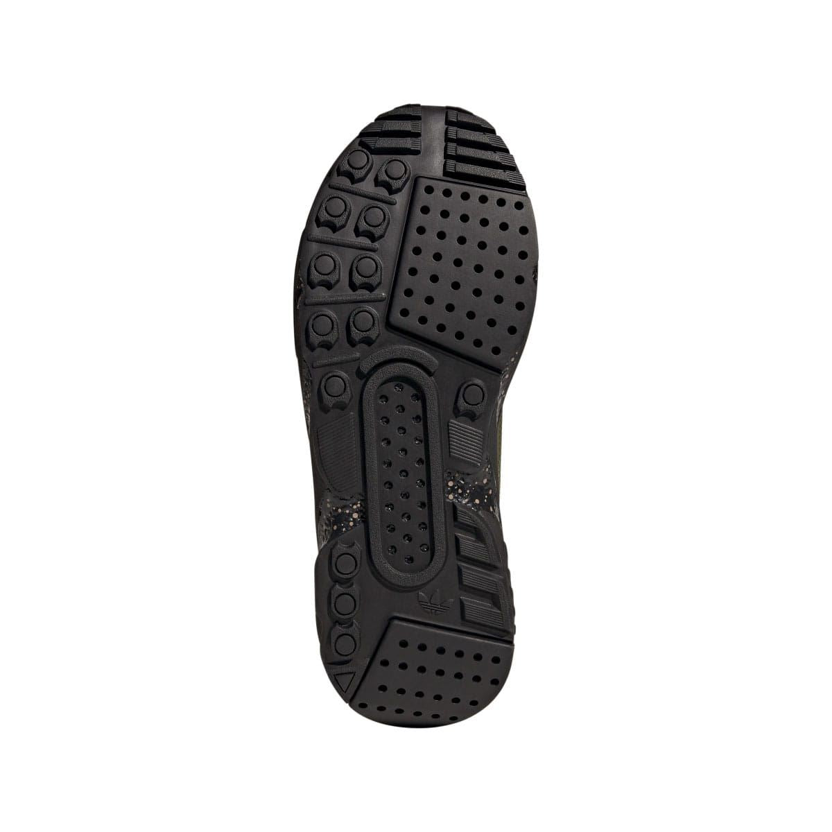 Black rubber outsole with tread pods and perforated grip pattern