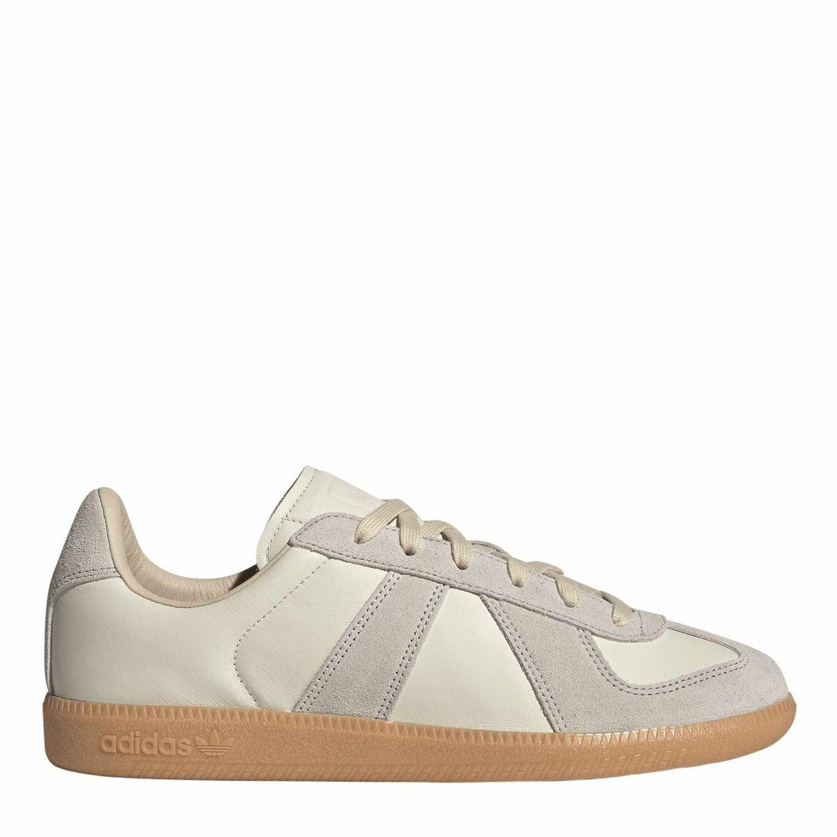 Light cream and gray low-top sneakers with three-stripe overlays and gum sole