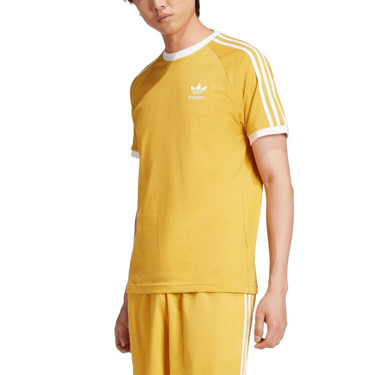 Yellow adidas T-shirt with white collar trim and three white sleeve stripes