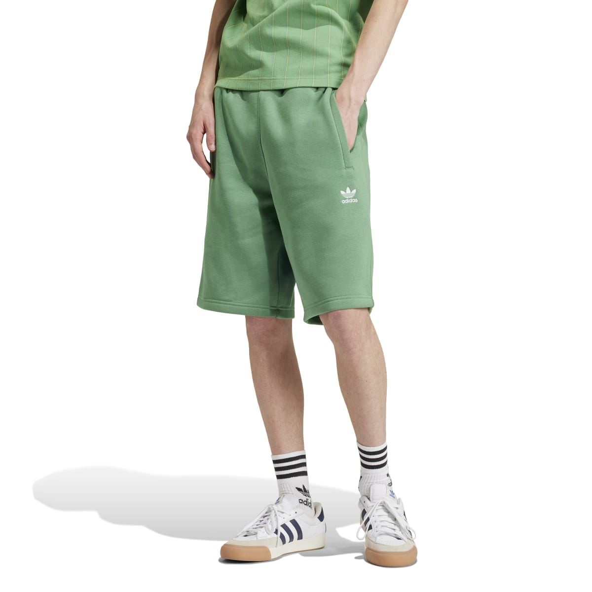 Green men's adidas trefoil shorts shown from side with elastic waist and logo