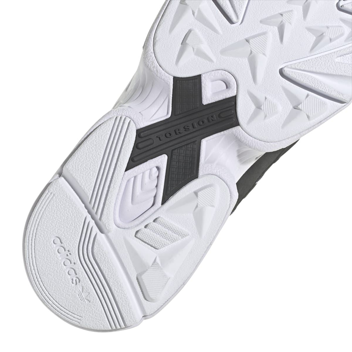 Close-up of white outsole with molded traction blocks and dark stability panel