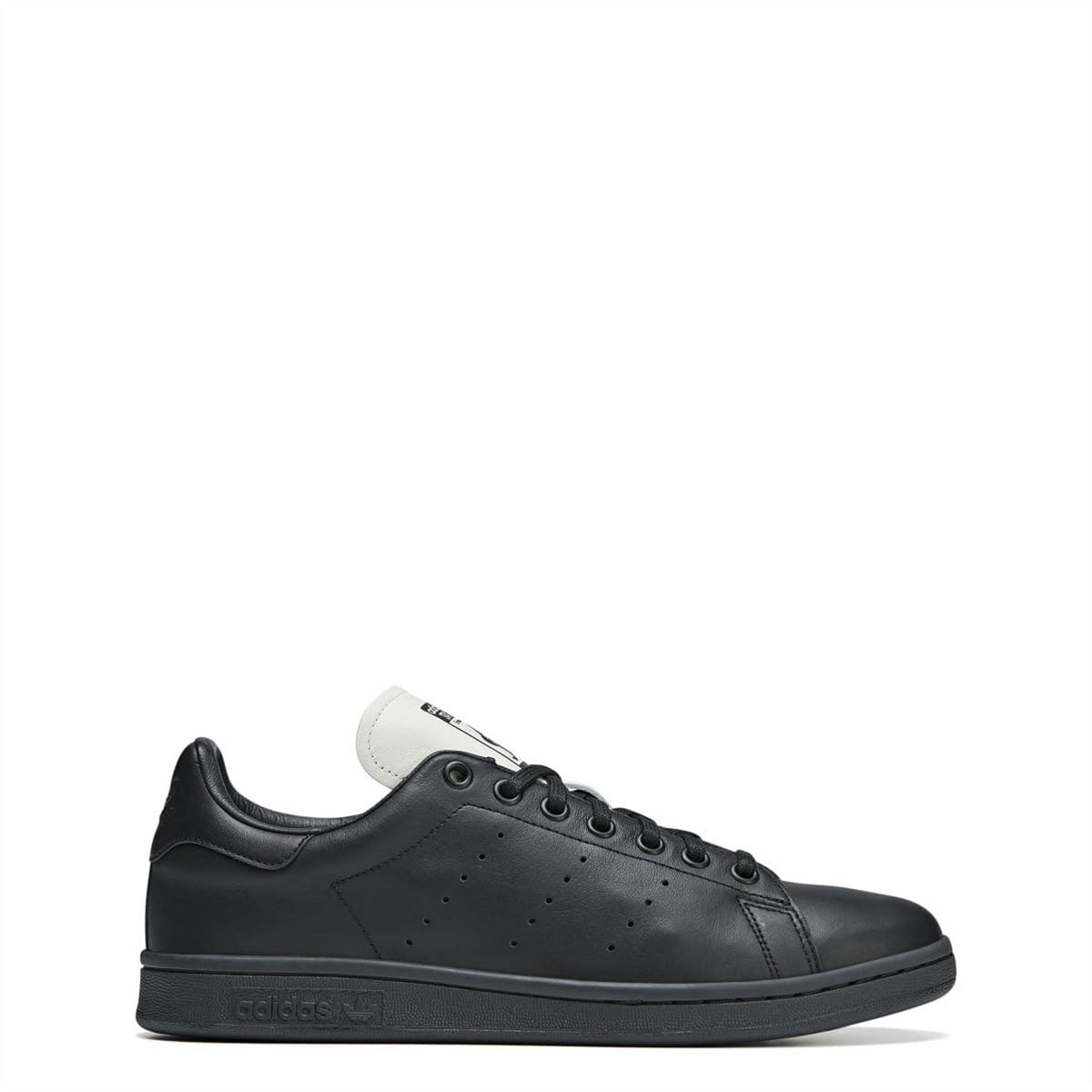 Black and white leather lace-up sneaker with perforated toe and adidas logo tongue