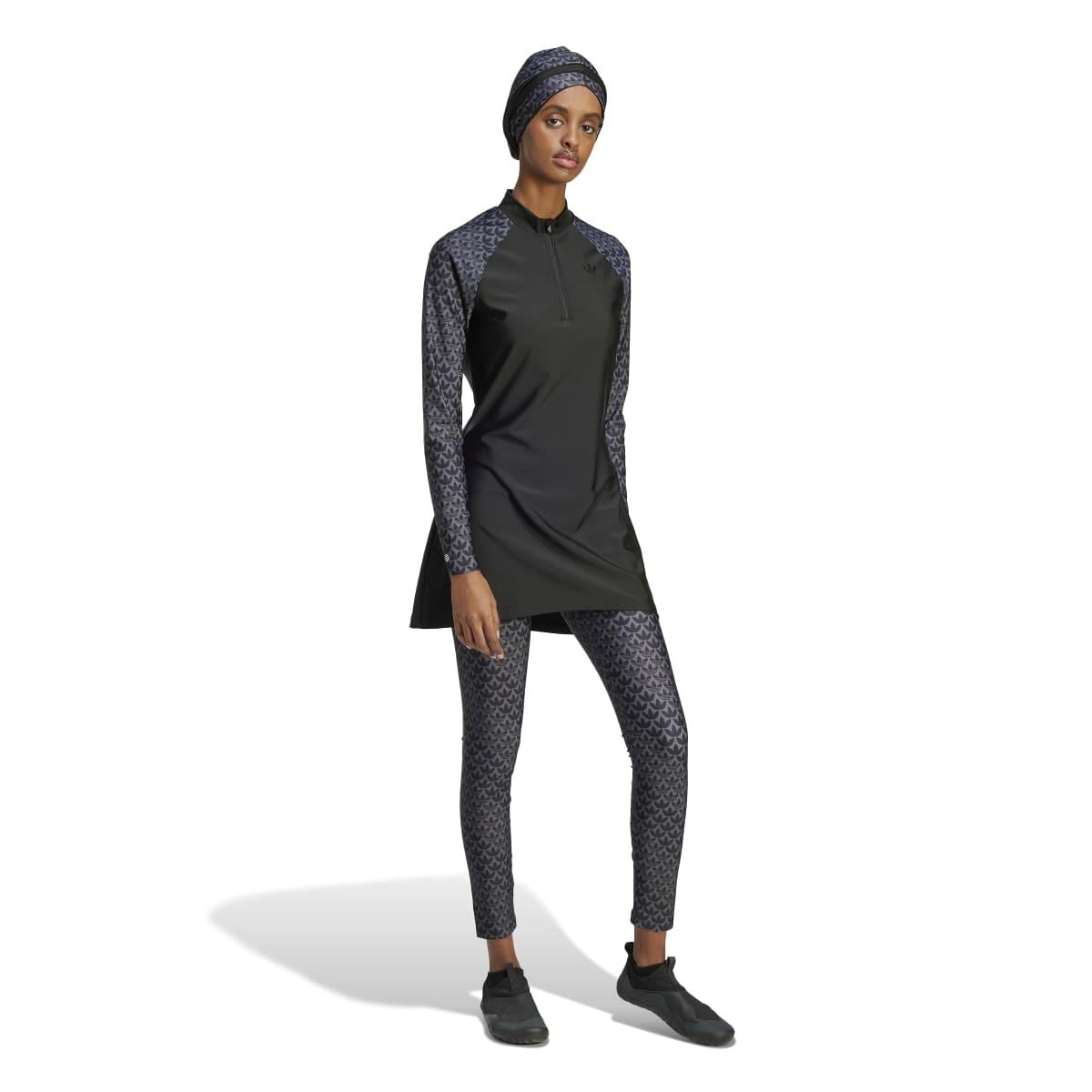 Black zip-front swim top with monogram sleeves and longer tunic hem
