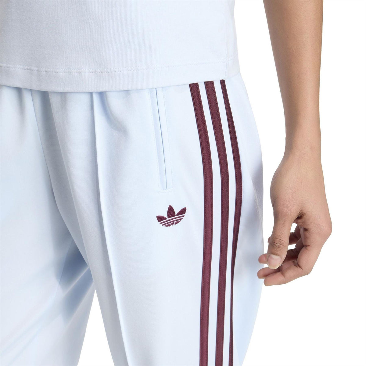 Womens white joggers with vertical maroon and off-white stripes and small trefoil