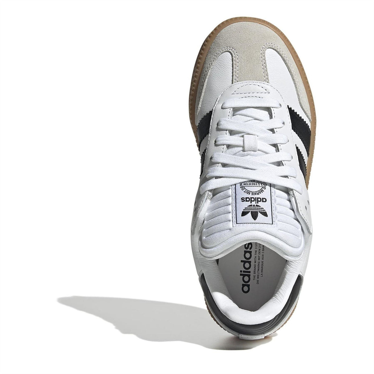 Kids white lace-up sneaker with black heel trim and gum outsole side