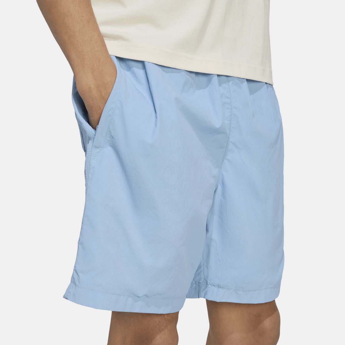 Light blue woven shorts with straight hem and subtle crinkle texture, side view
