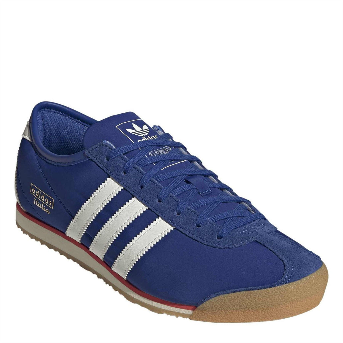 Royal blue low-top trainers with white stripes, lace-up closure, and red-accent sole