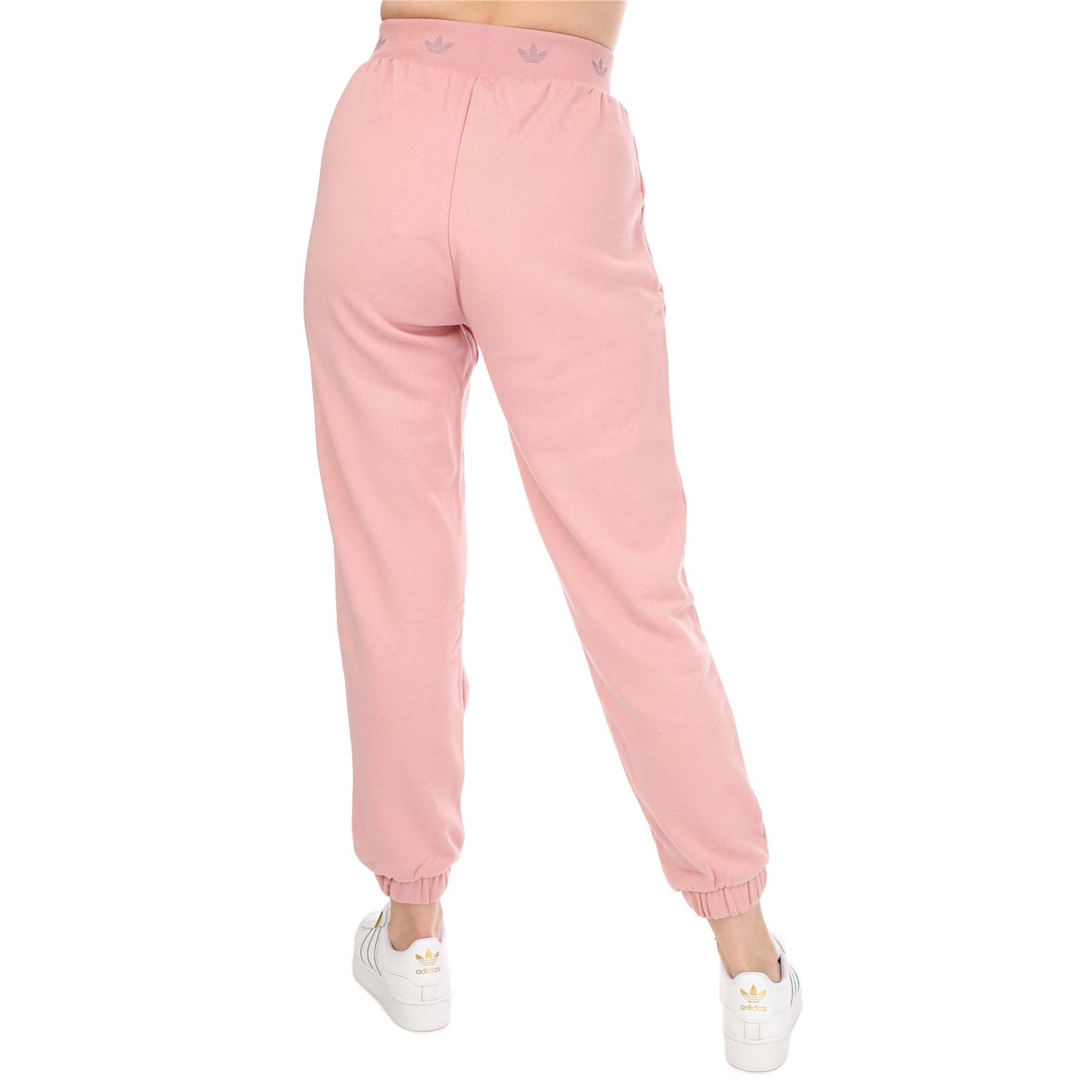 Pink adidas cuffed joggers with elastic waist and tapered legs